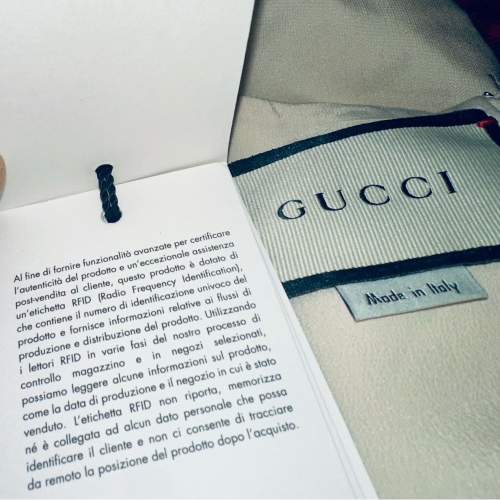 Gucci Red, Crème and Black Asymmetrical Dress with Gucci ivory dress cover. - Picture 13 of 15